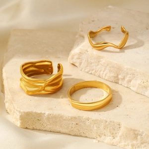 Three-piece gold stainless steel ring set with irregular lava texture on stone base