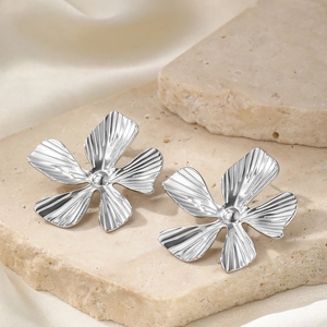 Elegant silver flower open ring with textured petals and metallic center on stone plate