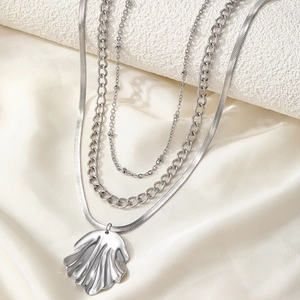 Three-layer silver necklace set with bead, tank, and snake chains plus a shell pendant