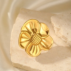 Detailed macro view of 18K gold flower ring with intricate petal texture and polished finish