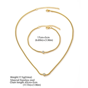 Detailed view of gold plated stainless steel jewelry set with crystal solitaire accents