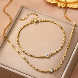 Elegant gold-plated jewelry set featuring a single zircon pendant necklace and bracelet