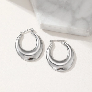 Detailed view of wide silver-toned hollow hoop earrings with a mirror-polished finish