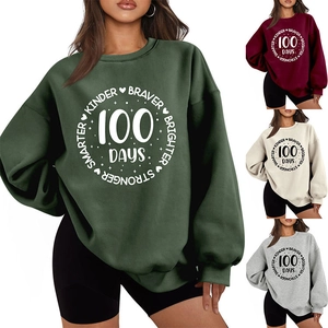 Detail of oversized dark green sweatshirt with Kinder Braver 100 Days printed graphic