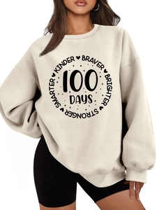 Close-up of cream crewneck sweatshirt featuring Kinder Braver 100 Days printed design