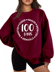 Detail of burgundy oversized sweatshirt with Kinder Braver 100 Days white graphic print