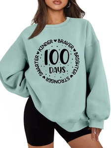 Detail of mint green sweatshirt featuring 100 Days motivational print and ribbed cuffs