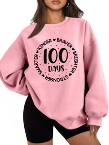 Detail of pink crewneck sweatshirt featuring Kinder Braver 100 Days printed graphic design
