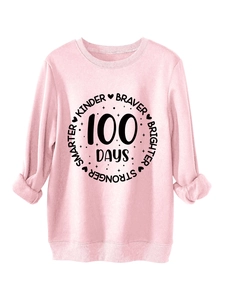 Close-up of pink crewneck sweatshirt with Smarter Kinder Braver Brighter lettering