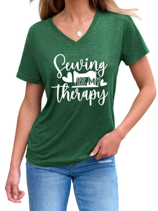 Close-up of heather green V-neck T-shirt with white sewing therapy print and sewing machine