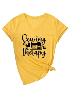 Detail of V-neck yellow T-shirt with 'Sewing IS MY therapy' print and knot hem design