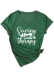 Detail of V-neck dark green t-shirt with sewing print and decorative knot at the hem