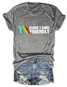 Flat lay of gray cotton t-shirt with DUDE I SAID FRIENDLY text and ripped denim shorts