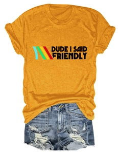 Detail of yellow cotton t-shirt with Dude I Said Friendly text and distressed denim shorts