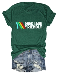 Close-up of Dude I Said Friendly graphic t-shirt paired with ripped denim shorts