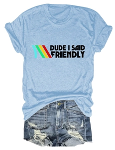 Flat lay of light blue T-shirt with Dude I Said Friendly text and ripped denim shorts