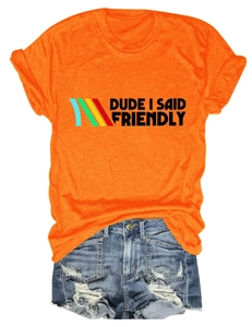 Detailed flat lay of orange slogan t-shirt with distressed denim shorts set