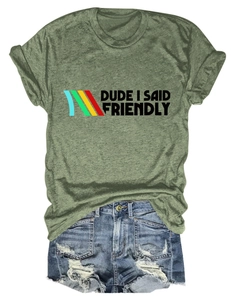 Flat lay of moss green T-shirt with Dude I Said Friendly text and ripped denim shorts