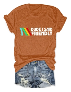 Close-up of orange t-shirt with Dude I Said Friendly print and color stripes