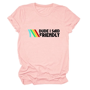 Close-up of pink t-shirt featuring DUDE I SAID FRIENDLY text and retro stripes details