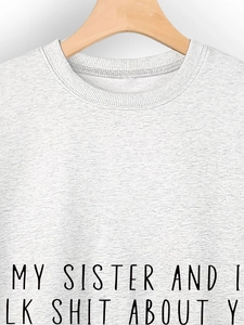 Close-up of Heather Grey sweatshirt neckline with My Sister And I Talk Shit text print