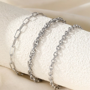 Three-piece silver chain anklet set featuring paperclip, rope, and classic link styles