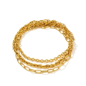 Set of three layered gold chain anklets featuring paperclip and thin ring link designs
