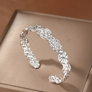 Adjustable silver open bangle with hammered texture surface and modern wavy edges