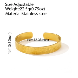 Detailed view of 1cm wide brushed gold stainless steel cuff showing weight and dimensions