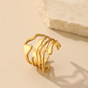 Detail of irregular hollow gold wave ring on stone background for a vintage baroque look