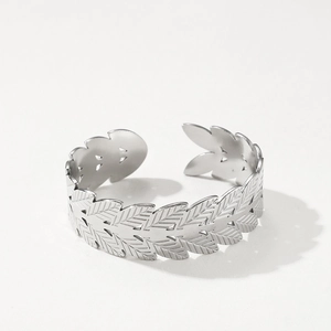 Macro shot of silver stainless steel leaf ring with detailed cutout wheat pattern