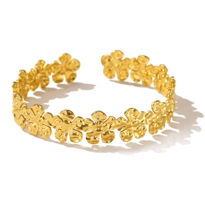 Detail of flower bangle with hand-hammered texture and continuous floral pattern design