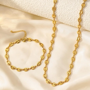 Detail of coffee bean link necklace and bracelet set in polished gold finish