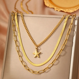 Three-layer gold necklace set featuring starfish pendant, snake chain, and paperclip link