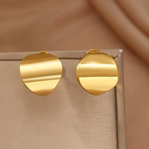 Polished gold irregular curved stud earrings displayed on a beige jewelry stand