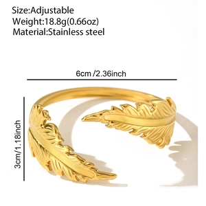 Detail showing adjustable gold feather cuff bangle with dimensions and weight specs