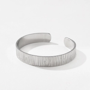 Modern silver-colored stainless steel cuff bracelet with unique vertical bark-like texture
