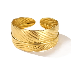 Polished gold feather cuff bracelet in stainless steel with detailed feather texture