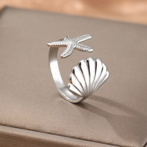 Adjustable silver shell and starfish open ring featuring a polished marine style design