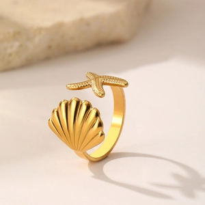Macro detail of golden starfish and seashell textures on an adjustable ocean-themed ring