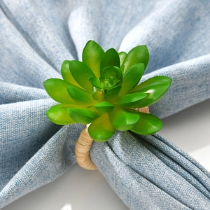 Faux succulent napkin ring with green leafy plant and woven natural wood base