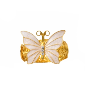Détail macro du rond de serviette doré avec papillon nacré et cristaux étincelants