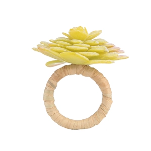 Detail of succulent napkin ring with faux green plant and woven raffia fiber base
