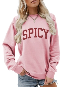 Detail of pink sweatshirt featuring red spicy varsity letter print and ribbed crewneck