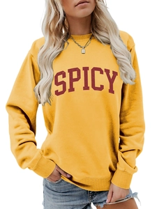 Detail of spicy red lettering on a yellow casual loose long sleeve sweatshirt
