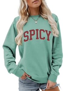 Detailed view of the mint green ribbed cuff and cotton fabric texture on sweatshirt