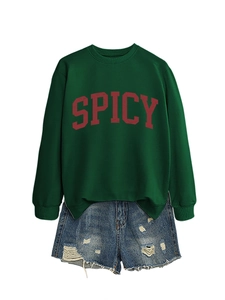 Detail of dark green Spicy sweatshirt featuring red lettering and casual ribbed cuffs