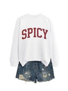 Detail view of casual white sweatshirt with red Spicy print and ripped denim shorts set