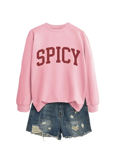 Detail of pink SPICY sweatshirt with distressed denim shorts as a casual women outfit