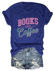 Flat lay of Books and Coffee graphic T-shirt with distressed denim shorts on white background